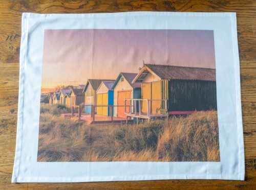 Chelsea Beach tea towel unfolded on table