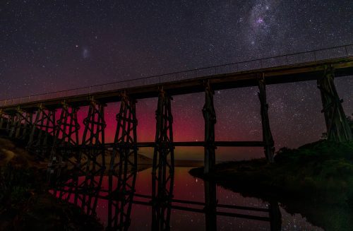 Aurora colors behind trestle bridge in Kilcunda