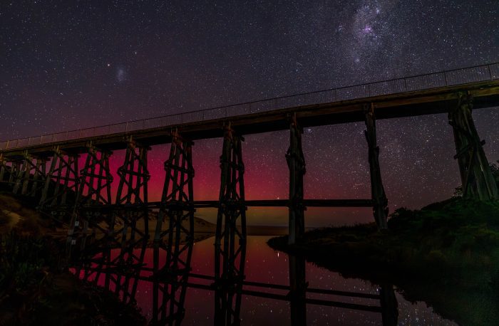 Aurora colors behind trestle bridge in Kilcunda