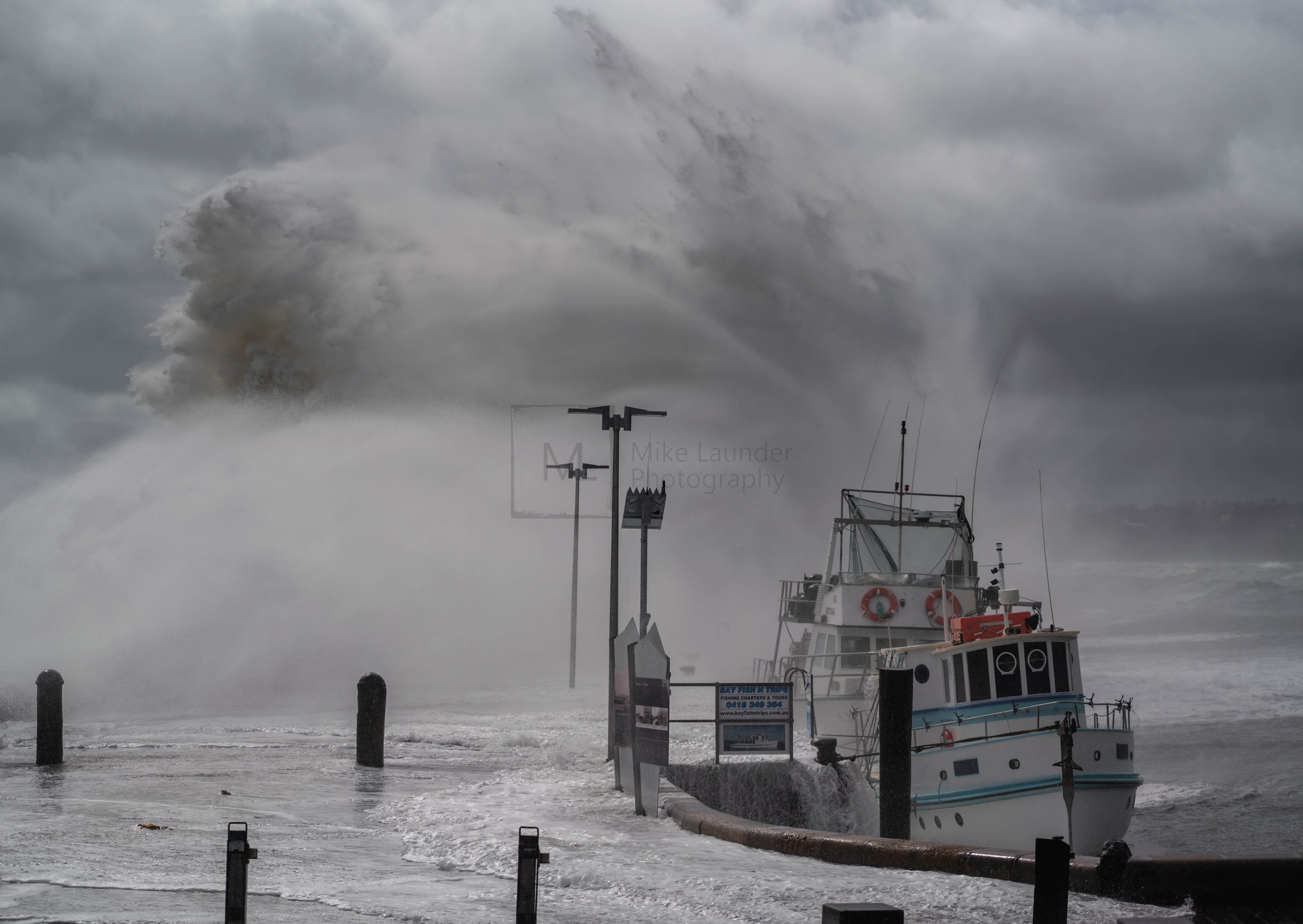 Large wave crashing into pier