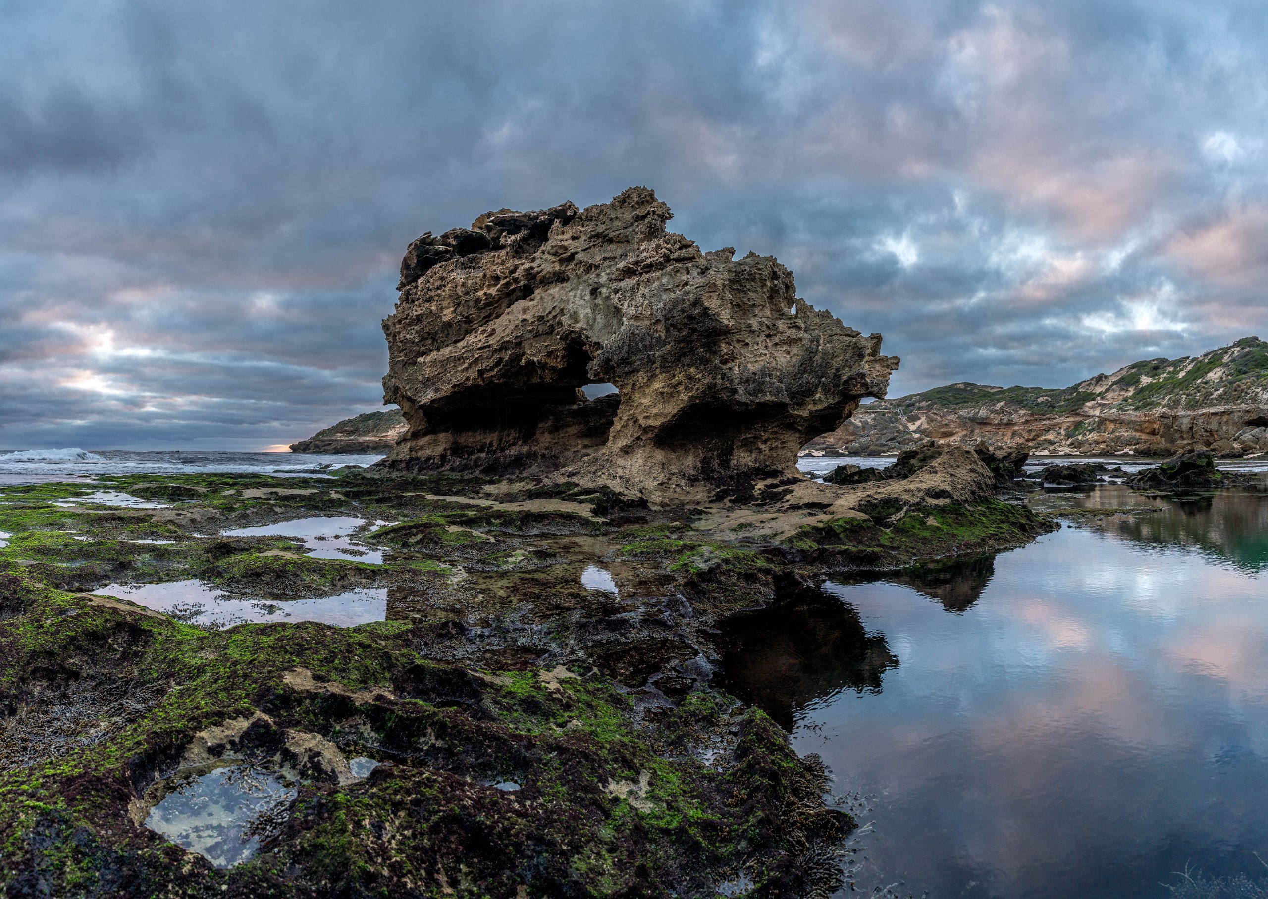 Large rock formation on ocean beach